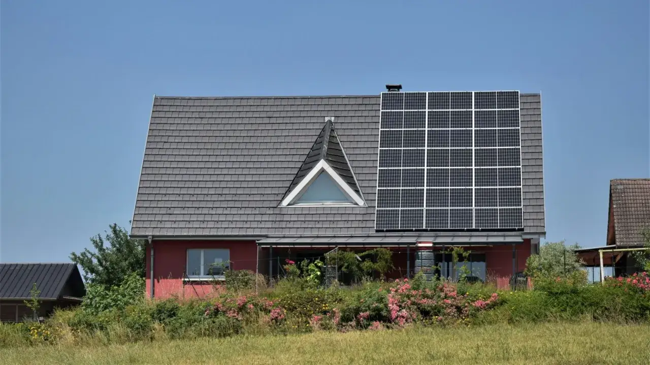 Dom z panelami słonecznymi, świadectwo troski o czyste powietrze i efektywność energetyczną. Audyt energetyczny potwierdził jego ekologiczne rozwiązania.